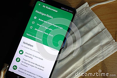Top view of corona app from the German government on a smartphone on a mask Editorial Stock Photo