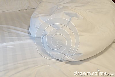 Top view of the crease of an unmade bed sheet in the bedroom after a long night sleep and waking up in the morning Stock Photo