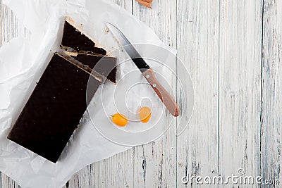 top view crunchy waffle cake with kumquat and knife on white wooden background Stock Photo