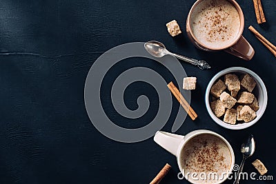 top view of cups of coffee, spoons, bowl of cane sugar and cinnamon stick Stock Photo