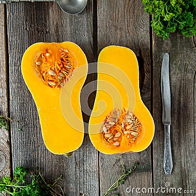 Top view Cut ripe orange pumkin with seeds on the rustic wooden table. Vegetarian, vegan, healthy diet food. Autumn harvest concep Stock Photo