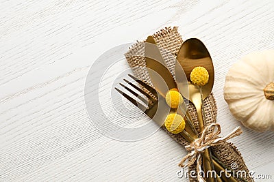 Top view cutlery decorated for autumn table setting and pumpkin on white wooden background, space for text Stock Photo