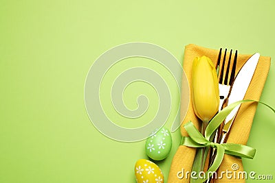 Top view of cutlery set with floral decor on background, space for text. Easter celebration Stock Photo