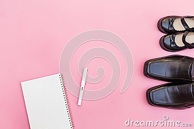 Top view daddy boots with daughter girl and notebook paper with Stock Photo