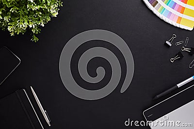 Top view of dark table graphic designer with color sampler, tablet and diary with copy space Stock Photo