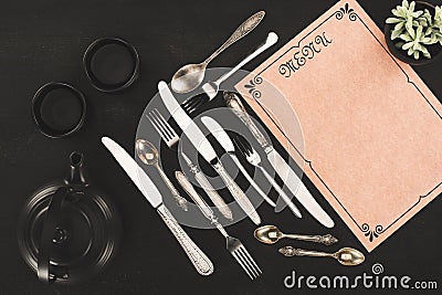 top view of decorative blank menu, vintage cutlery and tea set Stock Photo