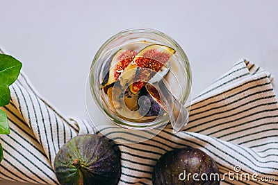 Top view Dessert of sour cream, vanilla, figs, nuts, honey and blue cheese in a glass on a marble Stock Photo