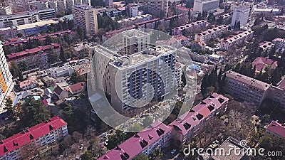 Top view of developed city on the background of mountainous landscape. Clip. Beautiful panorama of large city in valley Editorial Stock Photo