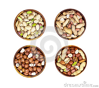 Top view of different nuts mix set: almonds, pistachios, peanuts, hazelnuts heap in round brown wooden bowl isolated on white Stock Photo