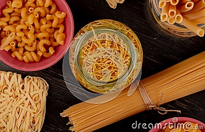 top view of different types of macaroni as bucatini cavatappi spaghetti vermicelli tagliatelle and others on wooden background Stock Photo