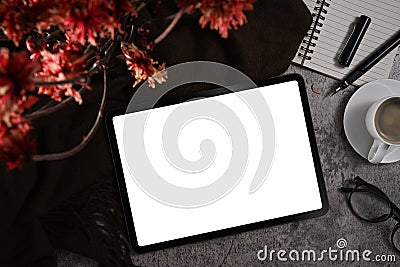 Top view digital tablet, flower pot, notebook, coffee cup and glasses on stylish workplace Stock Photo