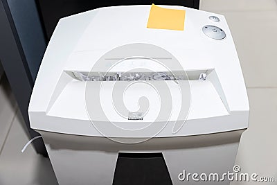 Top view of document shredder with papers overflowed from inside the machine Stock Photo