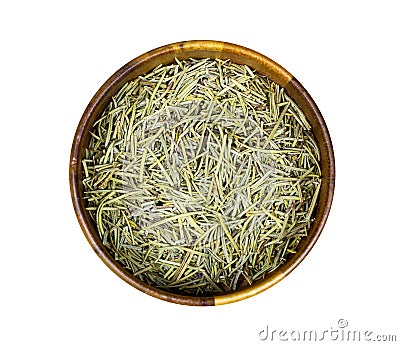 Top view of dried rosemary branches, twigs and leaves in a round wooden bowl isolated on white background. Stock Photo