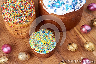 Top view easter cupcakes with icing and eggs on brown wooden surface. Stock Photo