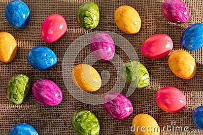 Top view of Easter eggs arranged randomly side by side on linen fabric. Easter. Stock Photo