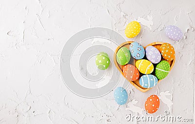 Top view easter eggs in shape heart isolated on white cement background Stock Photo