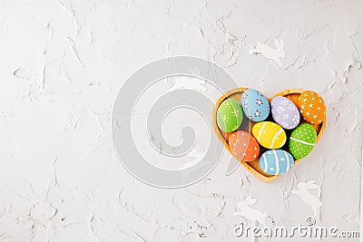 Top view easter eggs in shape heart isolated on white cement background Stock Photo