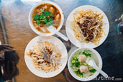 Top view of egg noodles with sprout served with fish in gravy and clear soup with minced pork. Street food in Taipei, Taiwan Stock Photo