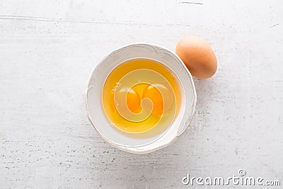 Top of view eggs in bowl on white concrete board Stock Photo