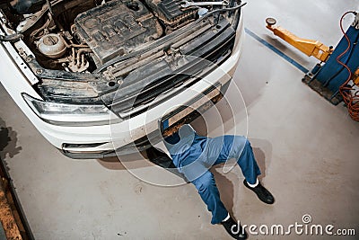Top view. Employee in the blue colored uniform works in the automobile salon Stock Photo