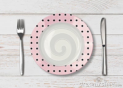 Top view of empty pink polka dot dish on wood table Stock Photo