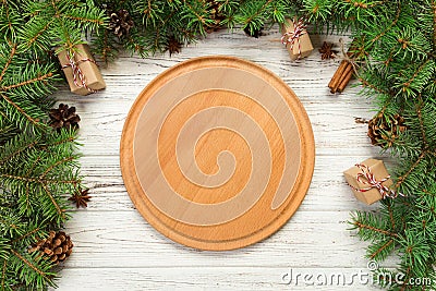 Top view. Empty wood round plate on wooden christmas background. holiday dinner dish concept with new year decor Stock Photo