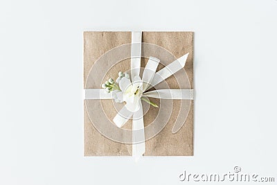 Top view of envelope with flower and ribbon isolated on white Stock Photo