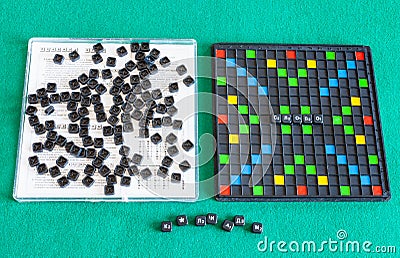 Top view of Erudite word game items on green table Editorial Stock Photo