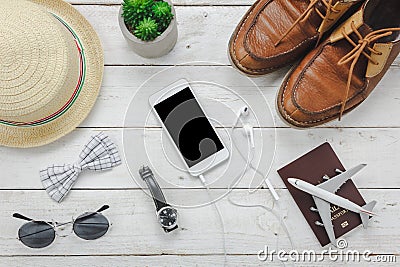 Top view / Flat lay accessoires to travel and technology with man / gentlemen clothing on white wooden table Stock Photo