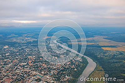 Top view of the evening city in fog, river, fields and forest Stock Photo