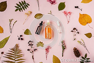 Face serum on pink floral background above. Stock Photo