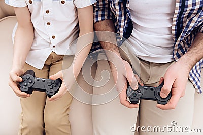 Top view. Father with son plays game using game controllers. Stock Photo