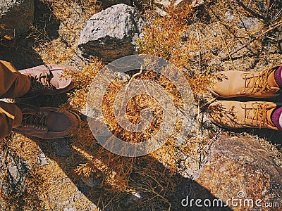 Top view of feet of young couple on dry golden grass Stock Photo