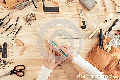 Top view of female carpenter hands working on desk Stock Photo