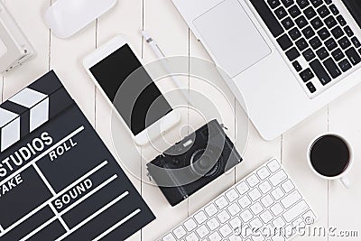 Top view of film clapper and gadgets on wooden desk Stock Photo