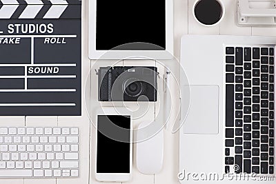 Top view of film clapper and gadgets on wooden desk Stock Photo