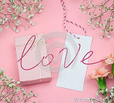 flat lay empty label and gift box pink background with inscription love, romantic gift card Stock Photo