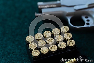 Top view, flat lay of handguns bullets and yellow noise canceling headphones on paper shooting practice target. After shooter Stock Photo