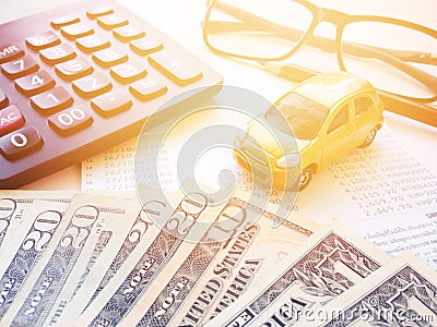 Top view or flat lay of miniature car model, American Dollars cash money, calculator and saving account book or financial statemen Stock Photo