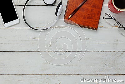 Top view / Flat Lay the pen / note book / white mobile phone / listening radio music Stock Photo