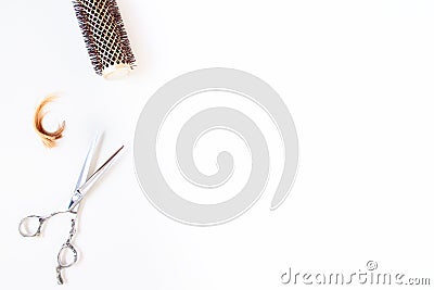 Top view flat lay of professional hair cutting shears, a piece of hair blond and brunette Stock Photo