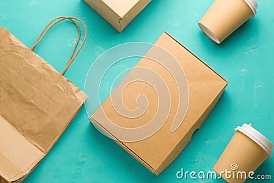 flat lay recyclable types of paper packaging on a blue background, paper bag, disposable glass, cardboard box Stock Photo