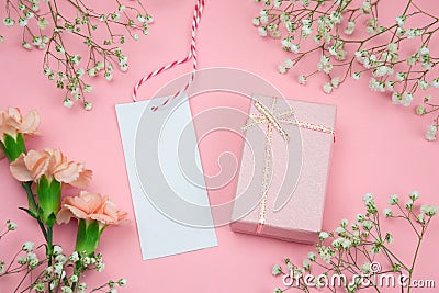 floral frame with mock up empty label and gift box pink background Stock Photo