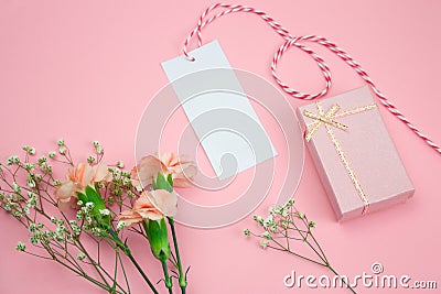 floral frame with mock up empty label and gift box pink background Stock Photo