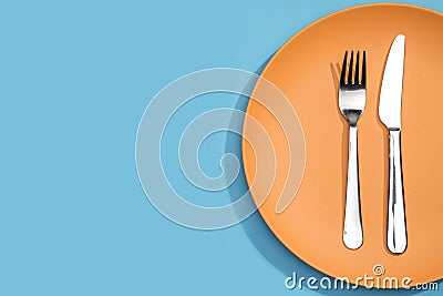 Top view fork and knife on plate with copy space Photo Stock Photo