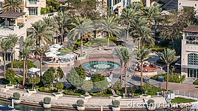 Fountain and palms timelapse at the Marina walk, During day time. Dubai, UAE Editorial Stock Photo