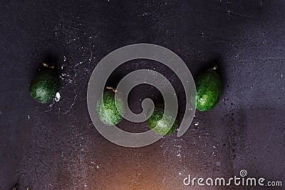 Top view of four green fruit feijoa on black background, close-up Stock Photo