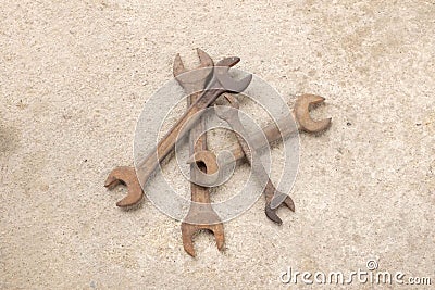 Top view group old rusted spanner wrenches Mechanic tool on grey concrete background Stock Photo