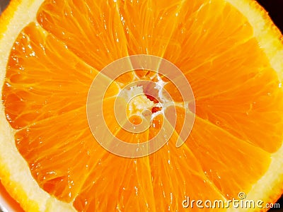 Top view of a fragment of the orange fruit slice close up. Macro background texture Stock Photo