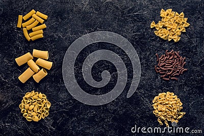top view of frame of various raw pasta on black Stock Photo
